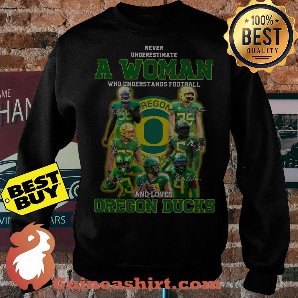 Never underestimate a woman football and loves Oregon ducks Signature sweatshirt