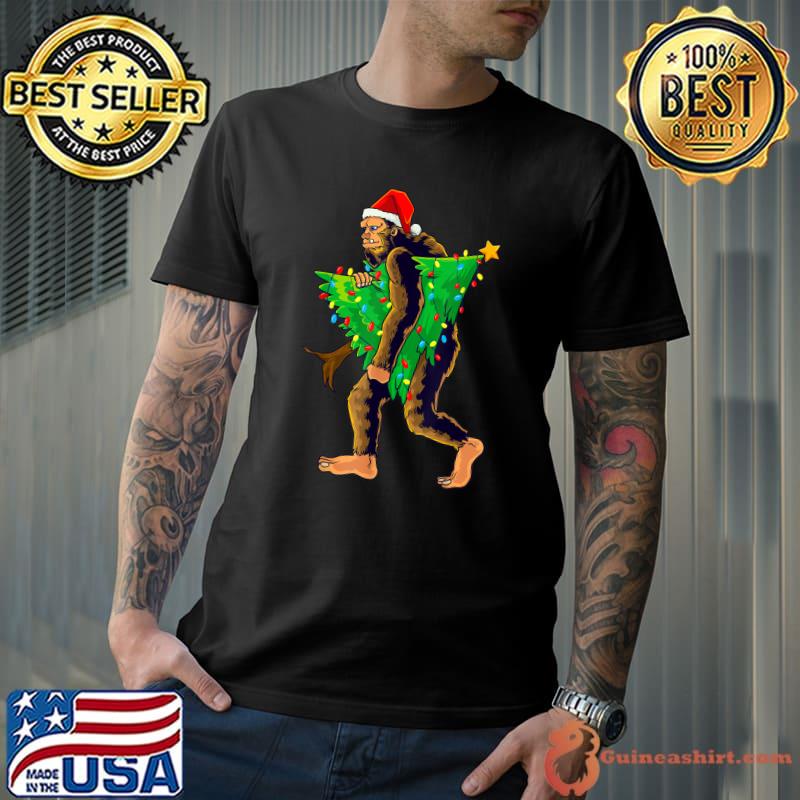 Bigfoot With Santa Hat Carrying Christmas Tree With Lights Sasquatch Believer Pajama T-Shirt