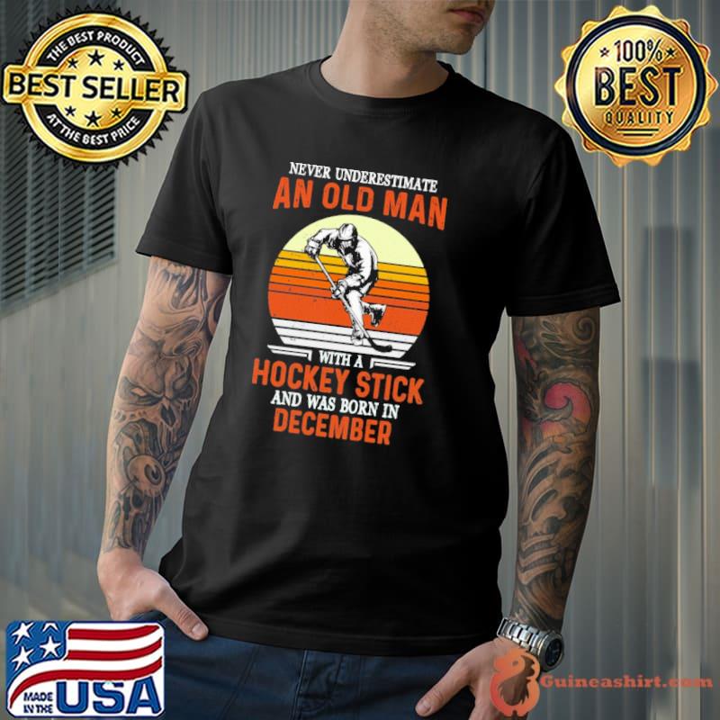 Never underestimate an old man with a hockey stick was born in December shirt